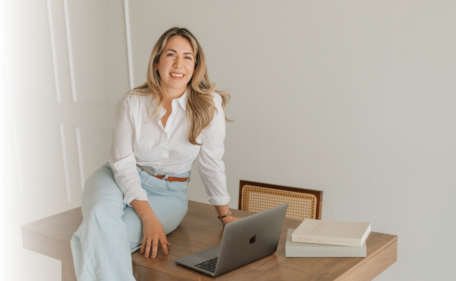 Therapist seated at a wooden desk in a warm office setting